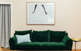 green couch in living room with photo