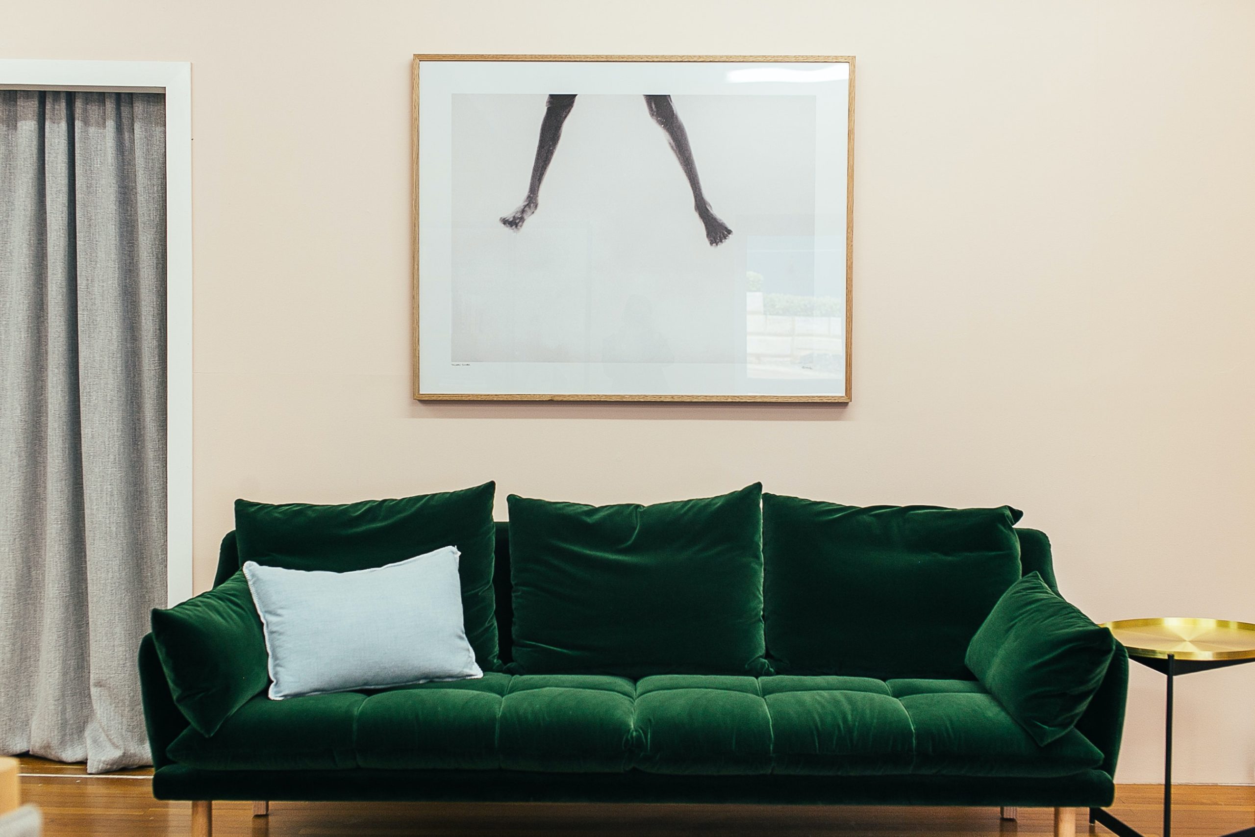 green couch in living room with photo